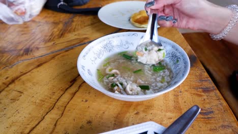 person enjoying a bowl of boiled rice