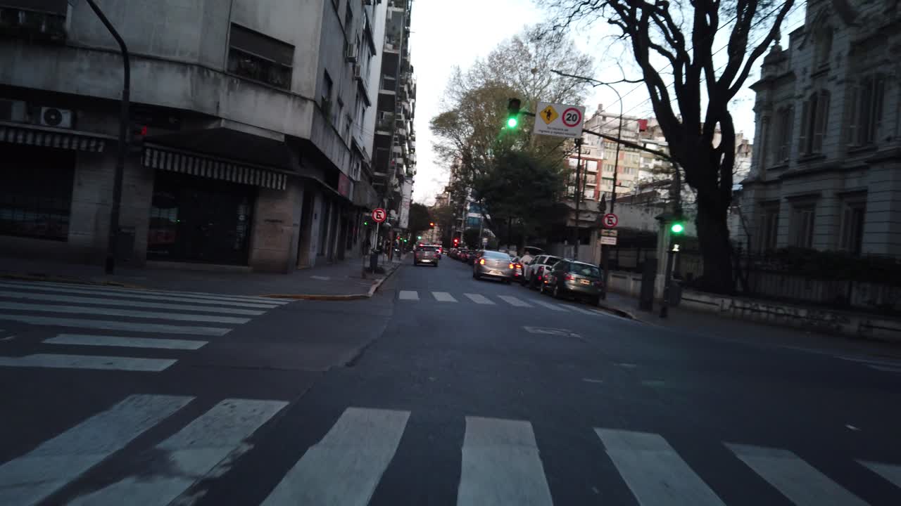 POV Window's seat view car driving through buenos aires city Recoleta streets at sunset