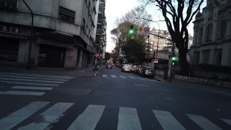 pov window's seat view car driving through buenos aires city recoleta streets at sunset