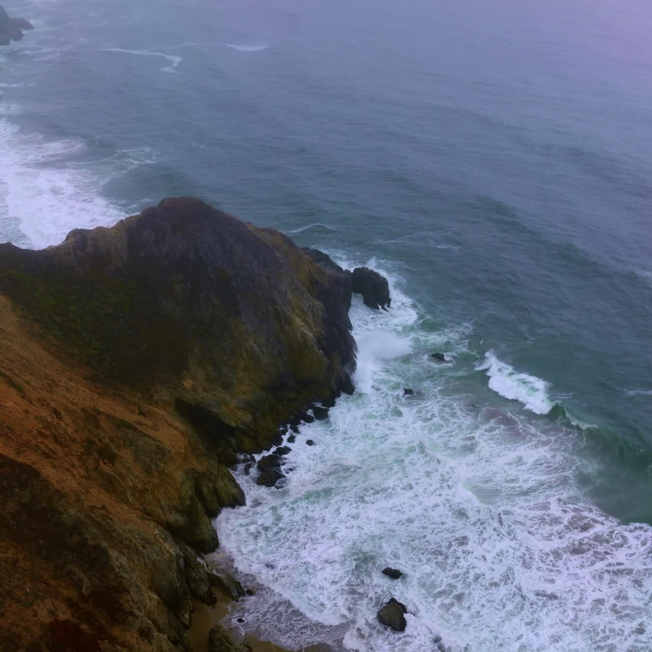 Waves of ocean moving slowly to the rocks at the waterfront. Montara State Beach at California, United States