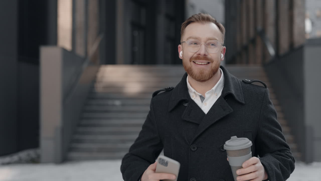 Man with phone and coffee