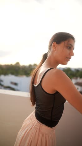 teenage ballerina dancing on rooftop