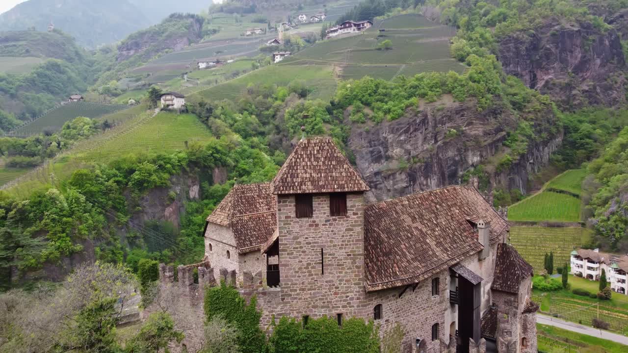 Historic castle in green mountain valley, aerial for travel, history and nature concepts