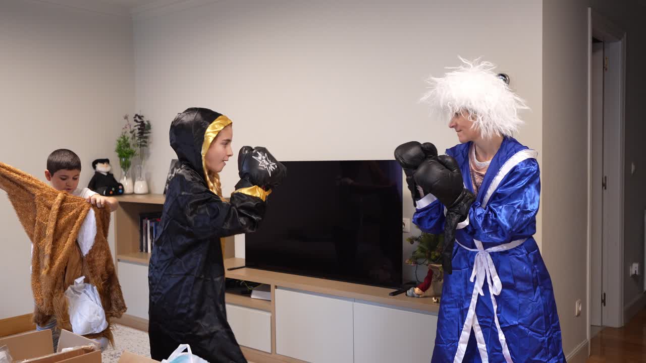 Mother and Daughter Playfully Boxing in Living Room