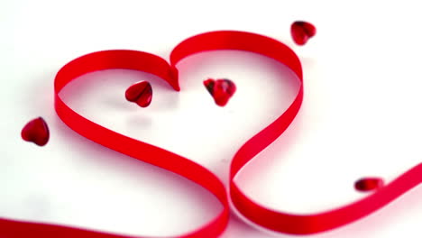 animation of red hearts and ribbon over white background