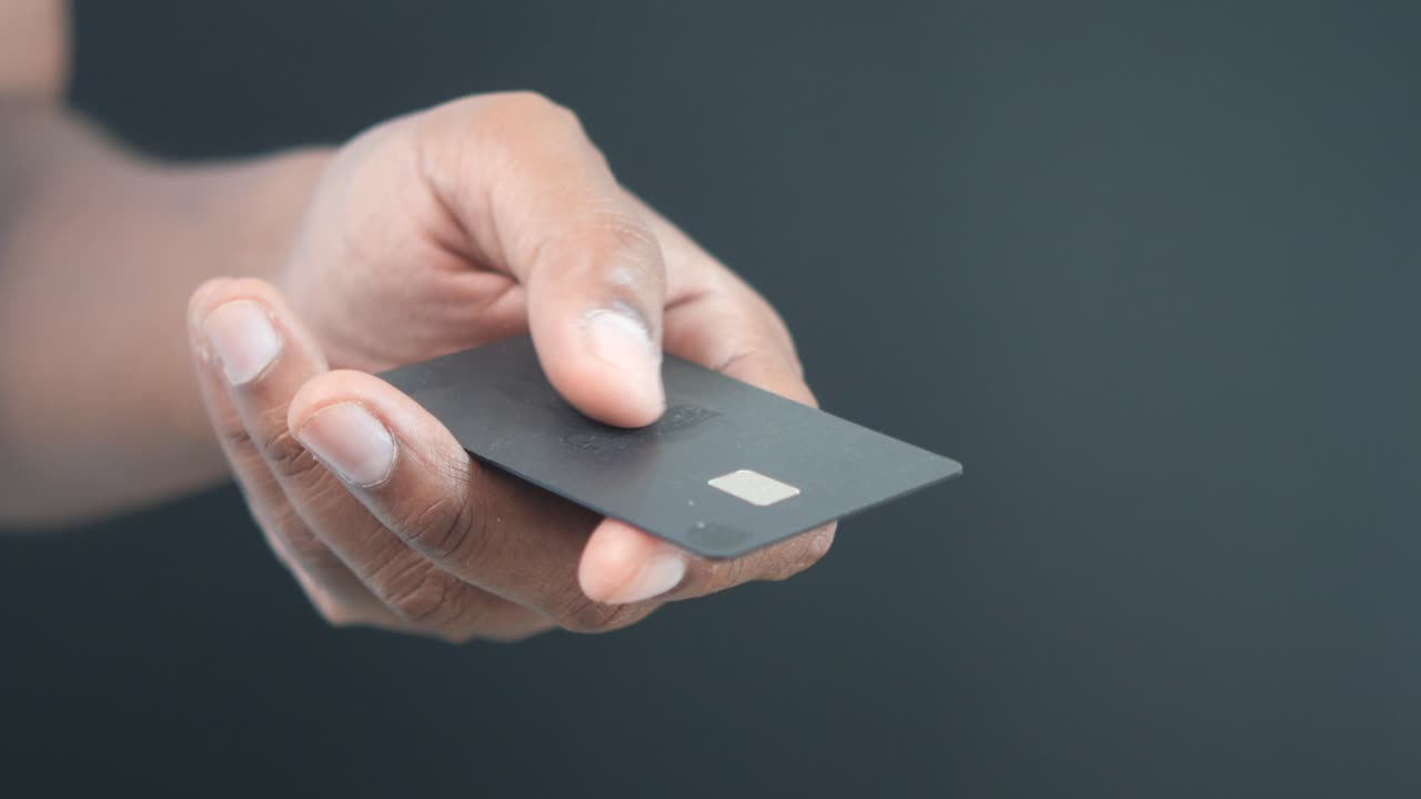 Hand Holding Black Credit Card