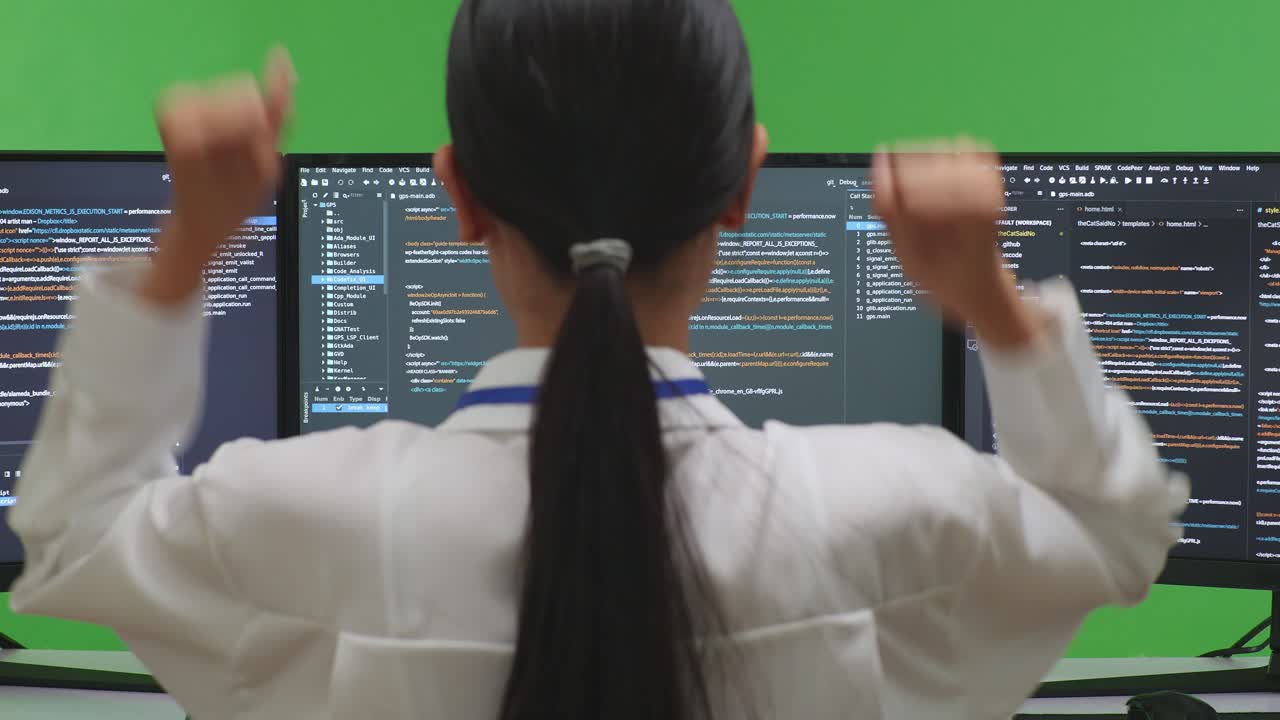 Woman Coding on Multiple Monitors
