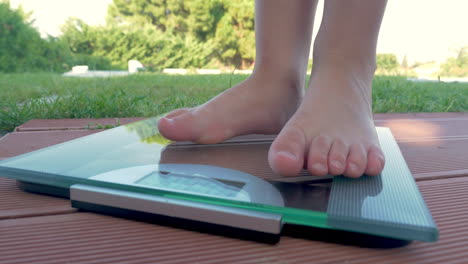 child standing to bathroom scales