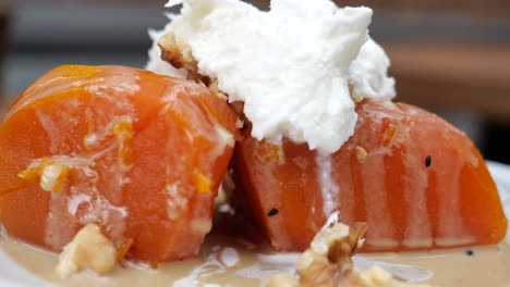 turkish pumpkin dessert (kabağı tatlısı) with whipped cream and walnuts