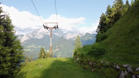 drone flight over forest with cable cars and alps in background