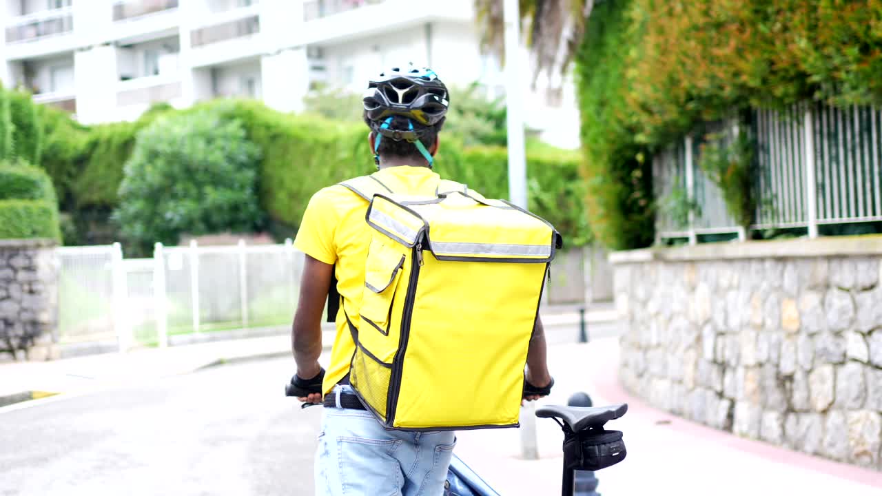 Delivery person with bicycle on the street