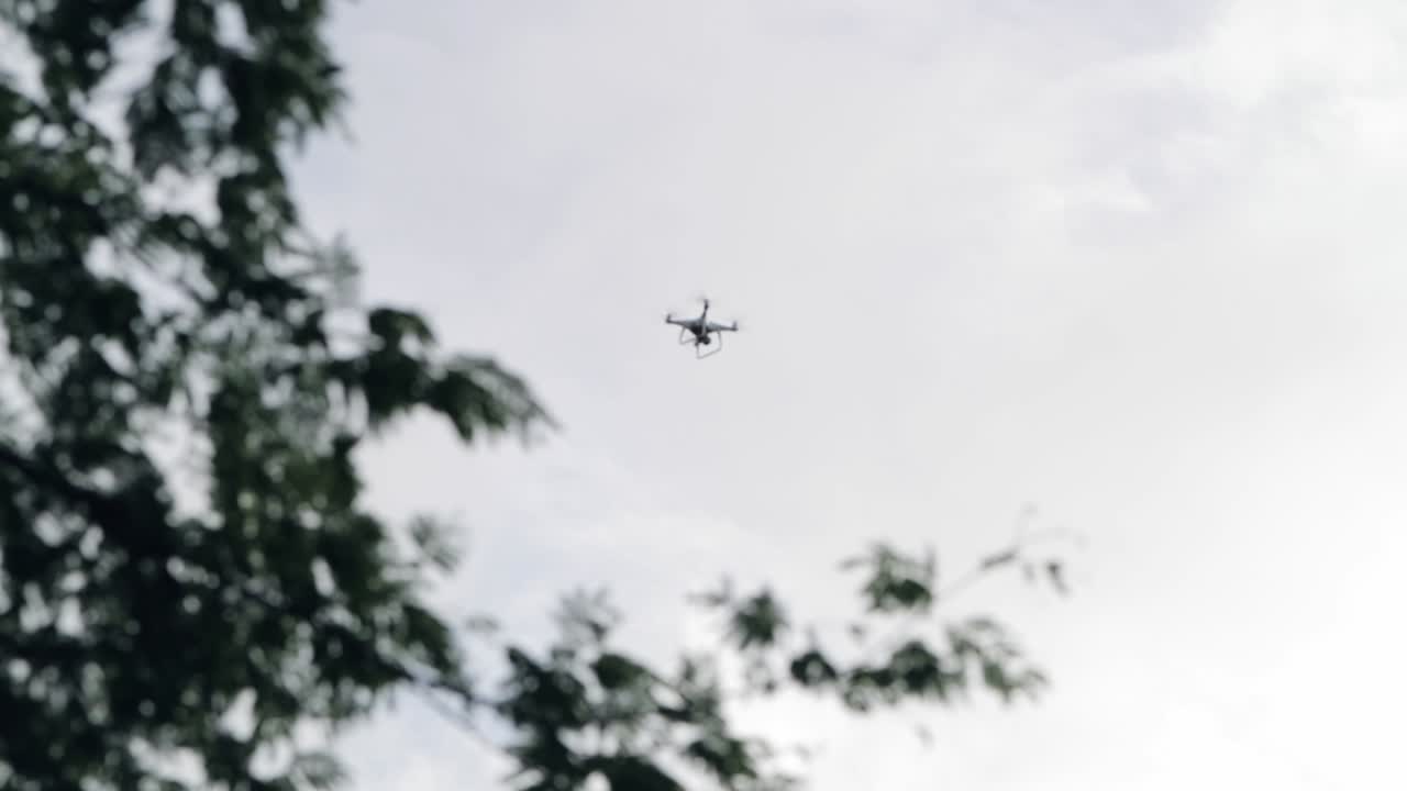 Tracking shot of drone flying against cloudy sky