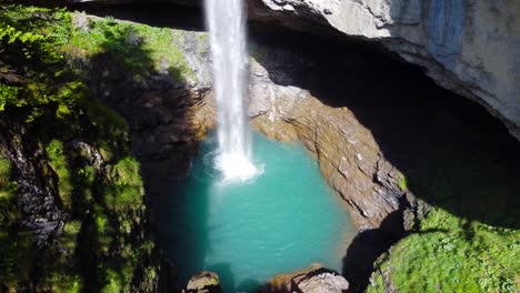 stunning aerial shot of berglistüber waterfall in switzerland