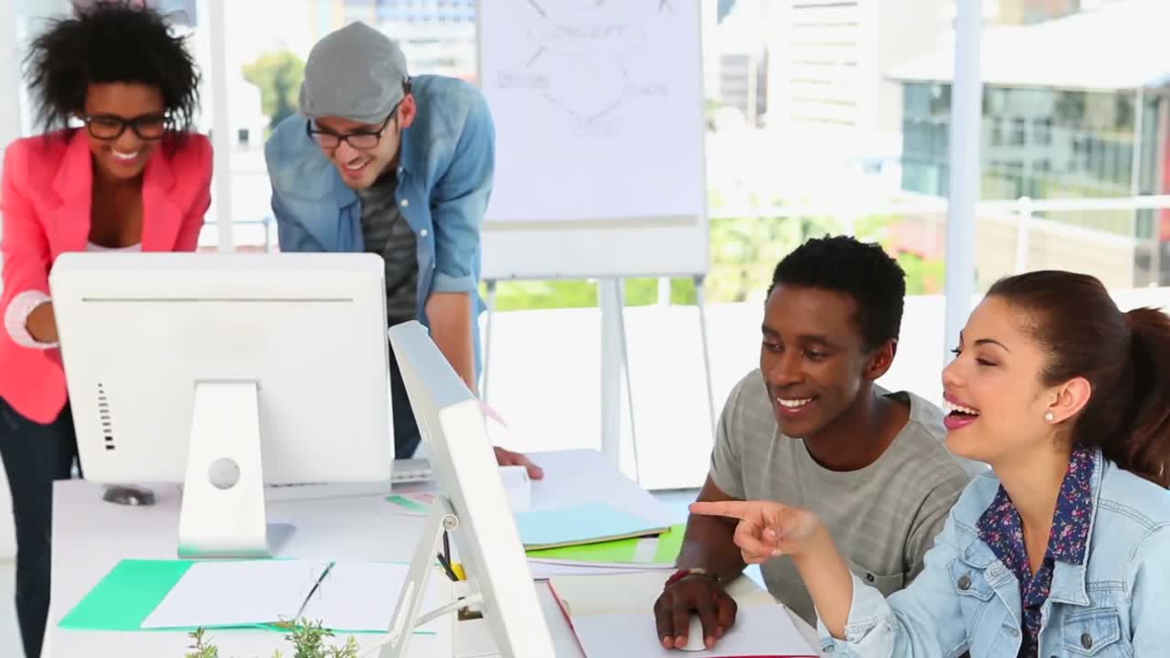 Creative partners working together looking at screen