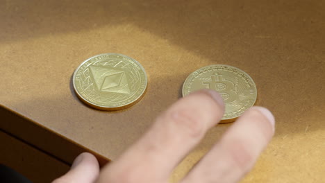 a mans hand choosing and ethereum coin over