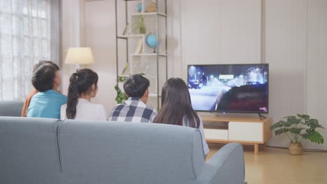 friends watching tv at home