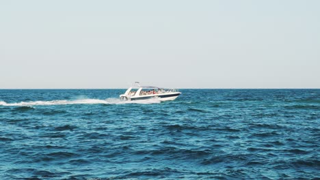 small cruise ship with passengers. small ferry with passengers crossing sea