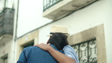 handheld shot of happy homosexual men walking and hugging