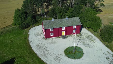 orbit drone shot of traditional dalslandsstuga house in the country during the day in dalsland, sweden