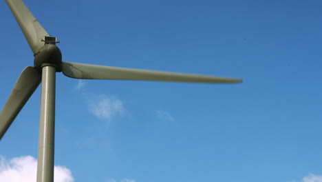 wind energy spinning against a blue sky