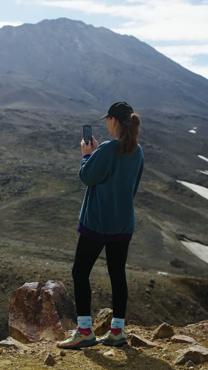 Woman Taking Photo of Mountain Landscape with Smartphone
