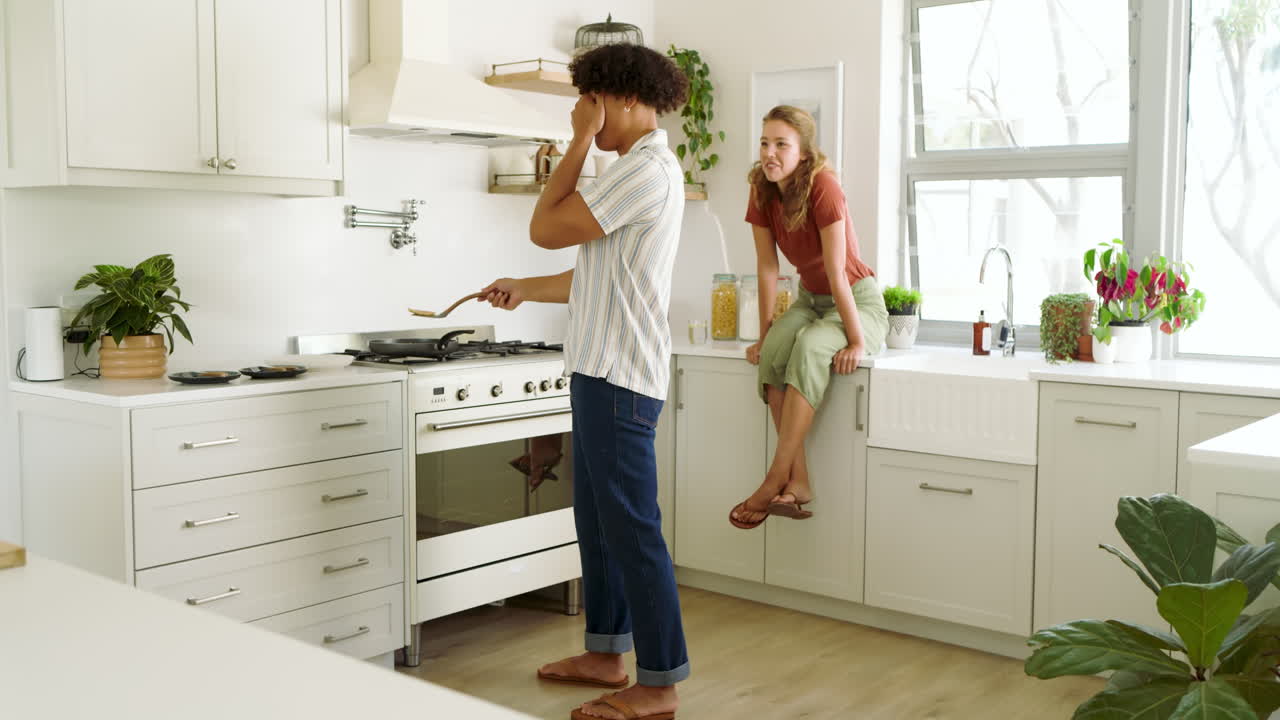 Young diverse couple cooking together in modern kitchen, enjoying quality time at home