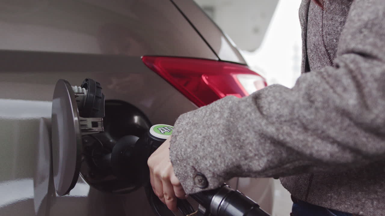 Woman Filling Up Car at Gas Station
