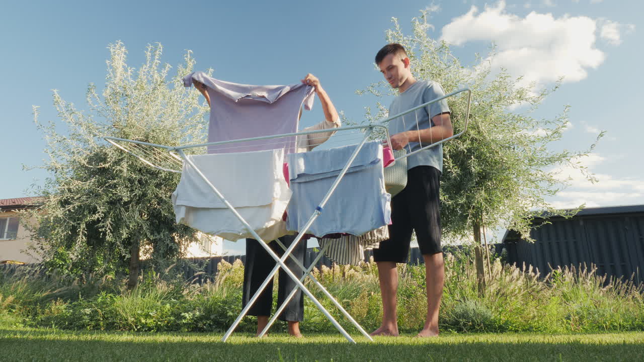 Couple hanging laundry in the garden