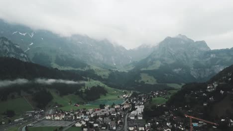 drone aerial going over the town of endelberg in switzerland in the mountains on cloudy day