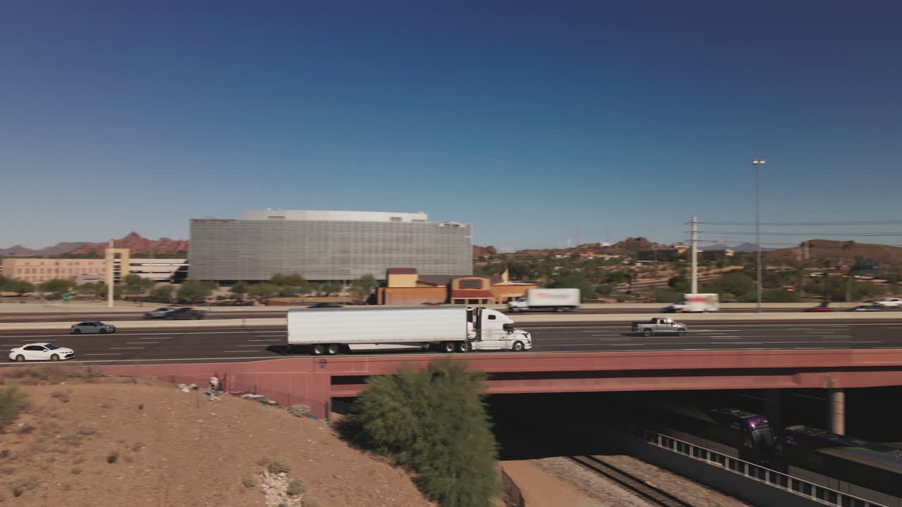 Highway with Traffic, Bridge, Train and Cityscape