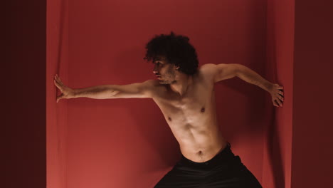 Young-man-dancing-in-a-red-room