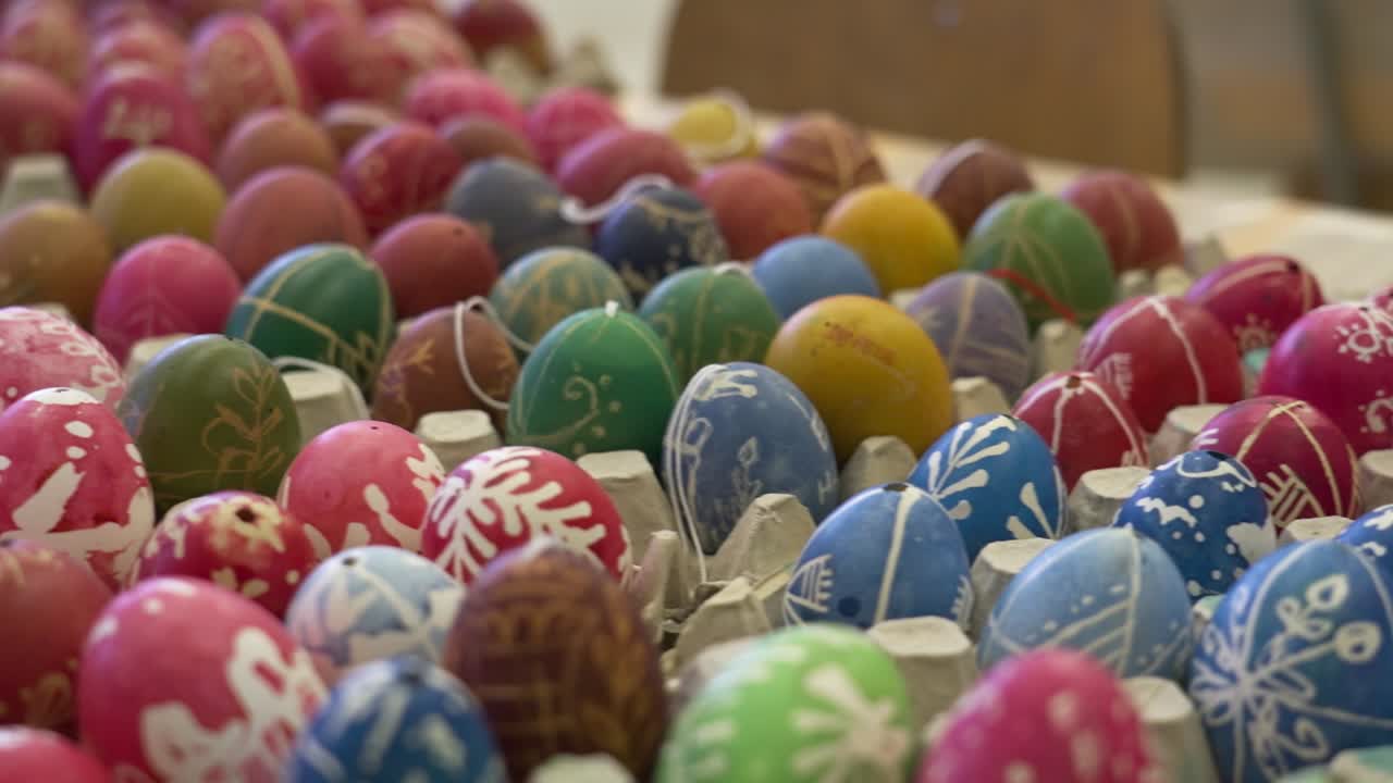 Soft pastel dyed traditional Easter eggs in various colors with floral wax patterns