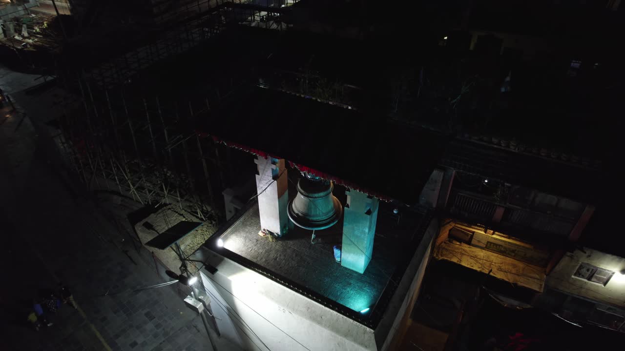 Aerial Night View of a Large Bell on a Rooftop in Kathmandu, Nepal