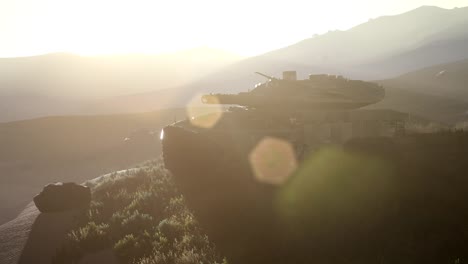 old rusty tank in the desert at sunset