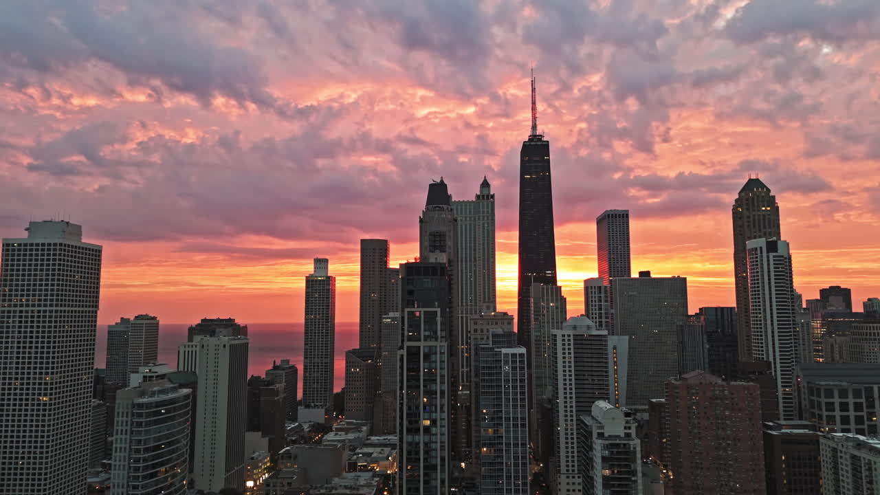 Aerial view approaching skyscrapers in Streeterville, dramatic dawn in Chicago