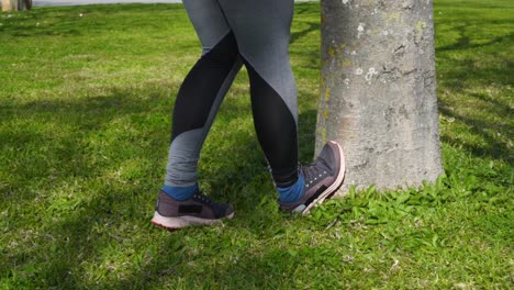 legs of young sporty woman exercising in park