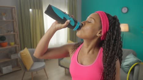 woman drinking water during exercise
