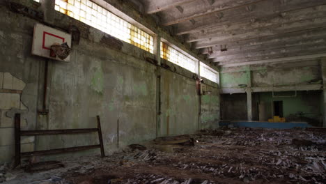 dilapidated basketball court in school of ghost town pripyat, zoom out view