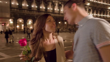 couple sharing a romantic moment in venice at night