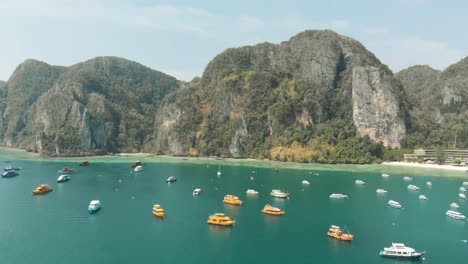 Pintoresca-Vista-Panorámica-De-La-Gran-Bahía-Llena-De-Barcos-Amarrados-En-El-Paraíso-De-La-Isla-De-Ko-Phi-Phi-Don-En-Tailandia---Toma-Panorámica-Aérea-Sobrevuelo