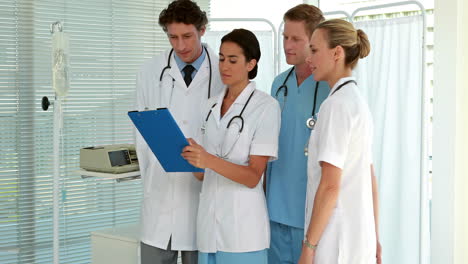 medical team looking at clipboard