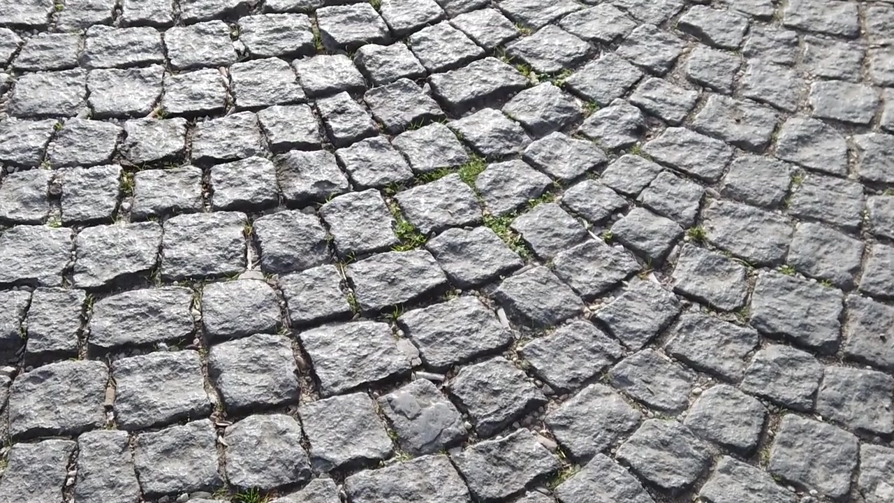 Slow motion footage of a cobble road.