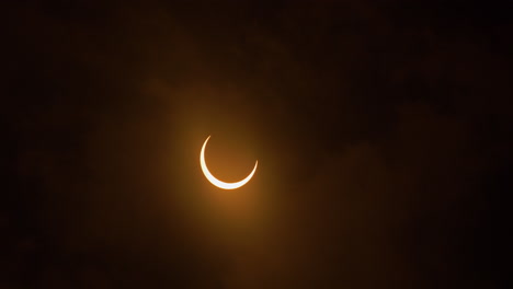 timelapse of an annular solar eclipse entering totality with clouds, october 14th, 2023