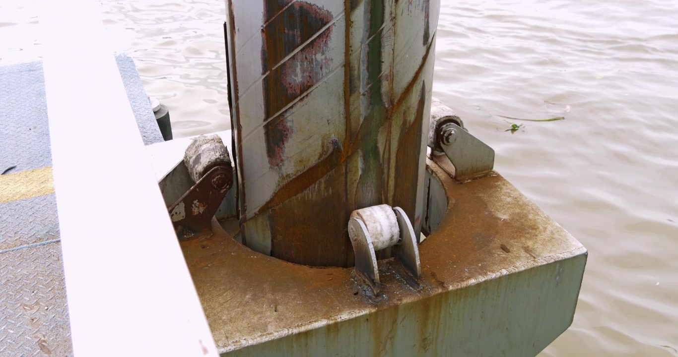 Palo d'attracco arrugginito con pali in acciaio regolabili e rulli per adattarsi ai mutevoli livelli dell'acqua nel fiume Chao Phraya, ideale per l'attracco delle imbarcazioni