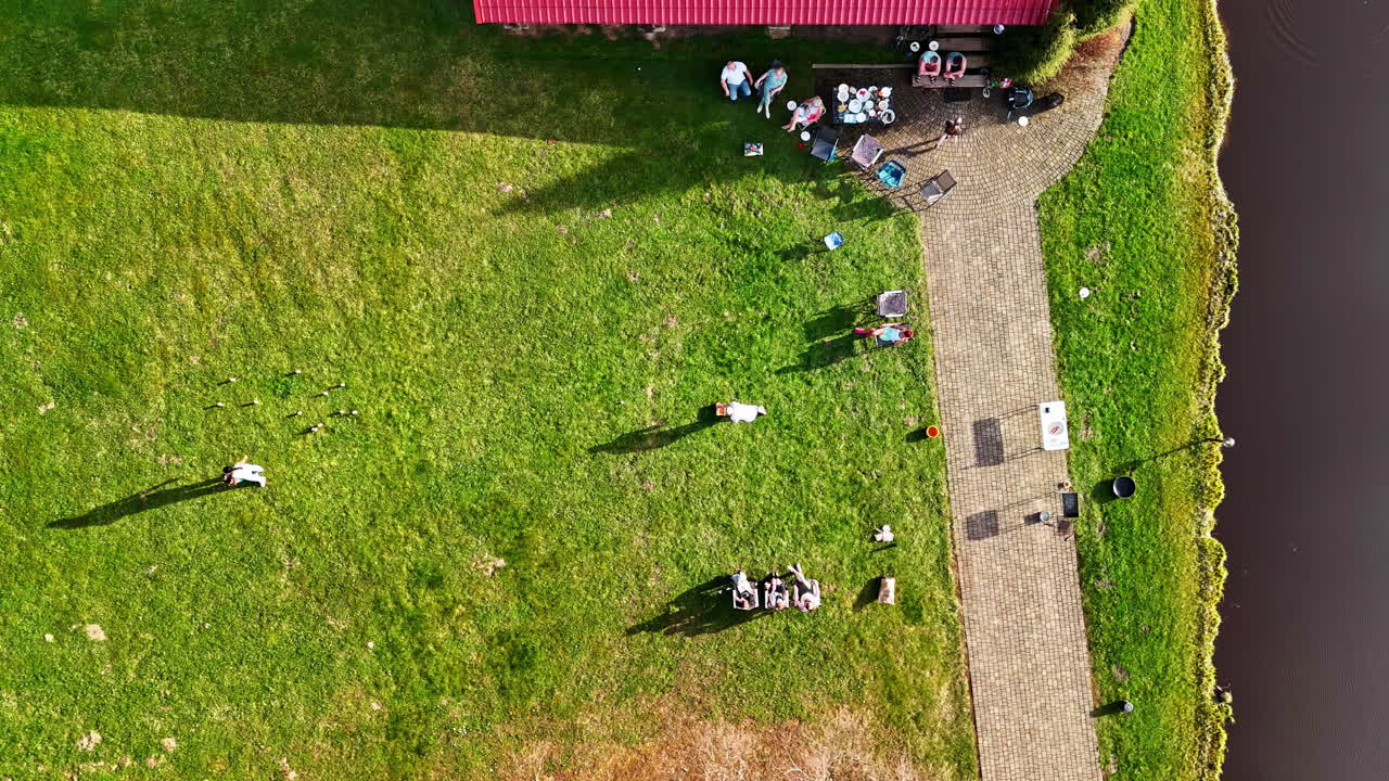 Aerial top shot of a family playing Mölkky game on a sunny day. Timelapse shot