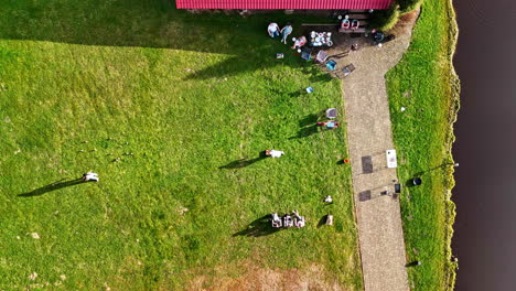 aerial top shot of a family playing mölkky game on a sunny day. timelapse shot