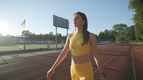 female athlete running on outdoor track in sportswear