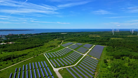aerial view of a large solar and wind energy farm by the coast