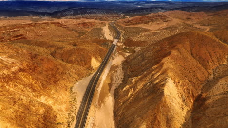 four lane speedway in the mountainous landscape of california. drone footage above the rocky scenery.