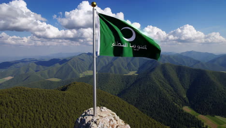 saudi arabia flag on a mountain peak